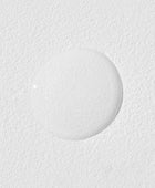 Close-up of a textured white surface with a circular object on it