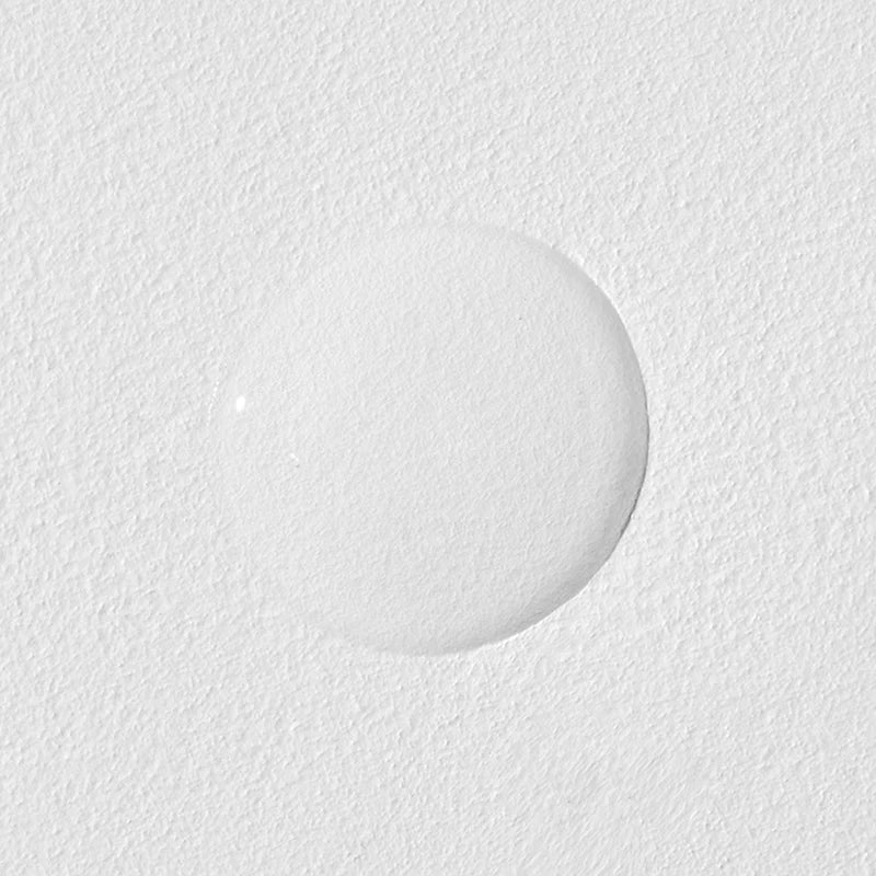 Close-up of a textured white surface with a circular object on it
