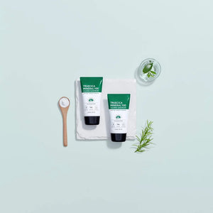 Two bottles of Truecica Pure All-In-One on a light blue background with green leaves and a wooden spoon.