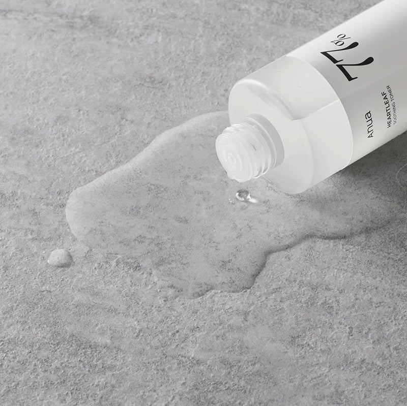 Tube of skincare product on a textured gray surface