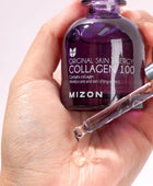 Mizon Collagen 100 skincare product being held in a hand with a dropper.