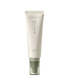 Tube of skin fluid with green cap on a white background