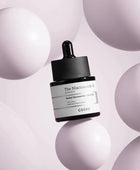 Cosrx skincare serum bottle on a light purple background with spherical shapes