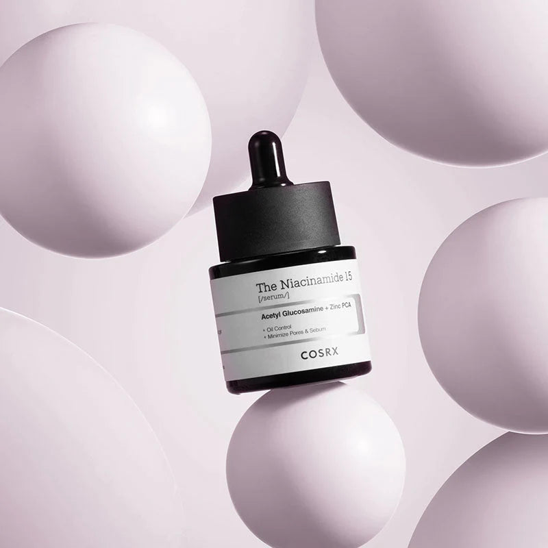Cosrx skincare serum bottle on a light purple background with spherical shapes