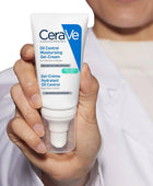 CeraVe oil control moisturizing gel-cream held in a hand with a blurred background