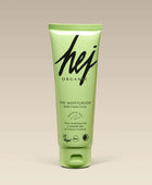 Green tube of hej organic moisturizer on a beige background
