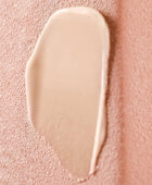 Beige cream swatch on a pink textured background