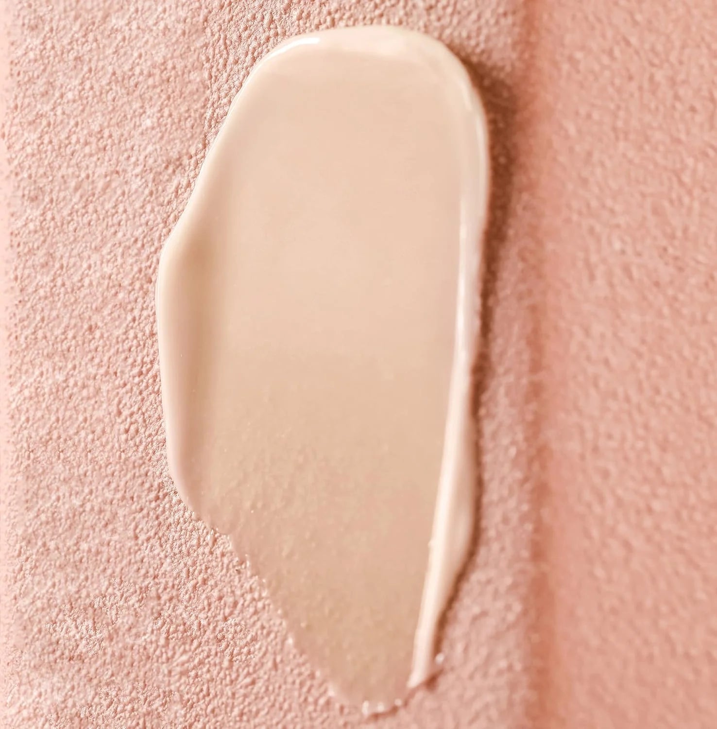 Beige cream swatch on a pink textured background