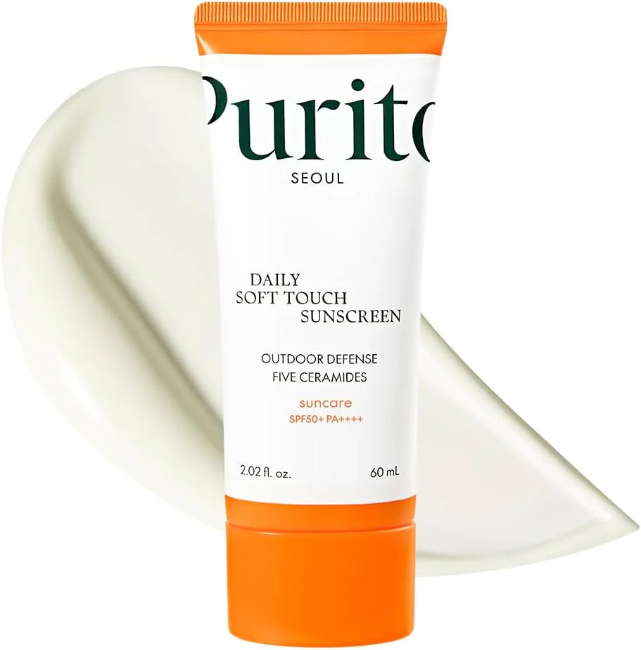 Purito Daily Soft Touch Sunscreen with orange cap and white label on a white background