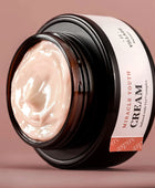 Jar of 'Miracle Youth Cream' with visible cream inside on a pink background