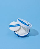 Round Lab compact powder on a light blue background