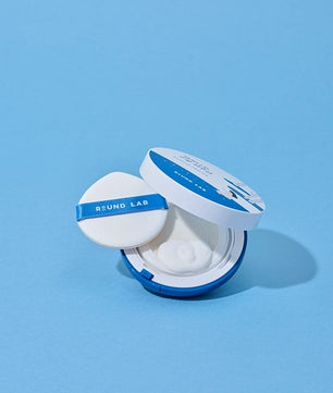 Round Lab compact powder on a light blue background