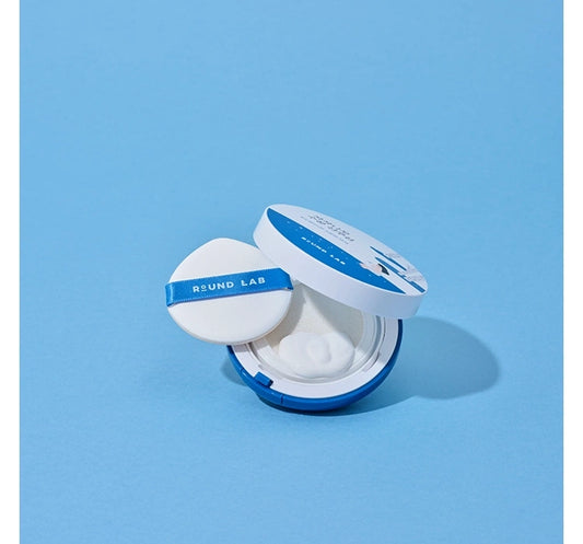 Round Lab compact powder on a light blue background